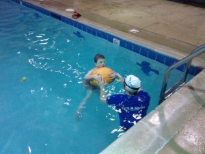 The week of Halloween there was a pumpkin in the pool as a flotation device. Here Ciaran is modeling its use.